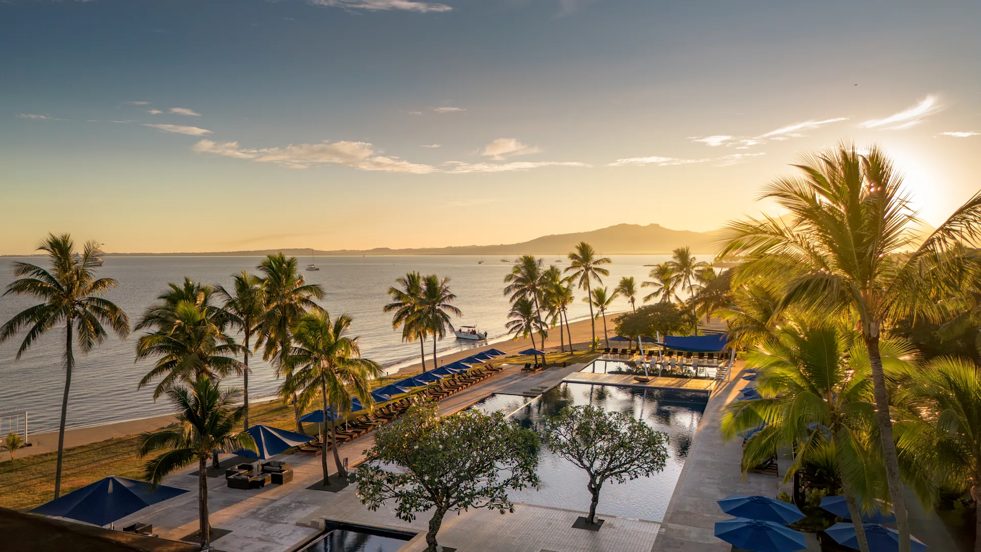Aerial view of Hilton Fiji Beach Resort pool and beach at sunset